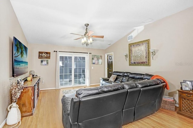 living room with light hardwood / wood-style flooring, ceiling fan, and vaulted ceiling