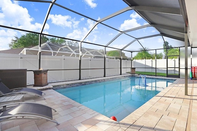 view of swimming pool featuring a patio area and a lanai