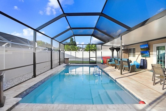 view of pool with a patio, glass enclosure, and an outdoor living space