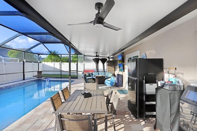 view of pool with ceiling fan, outdoor lounge area, a patio, and a lanai