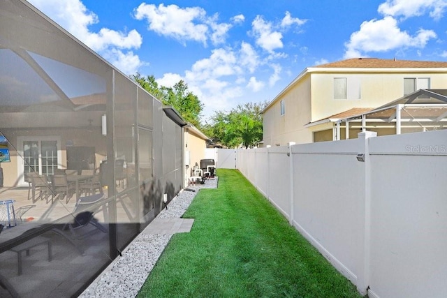 view of yard with a patio and glass enclosure