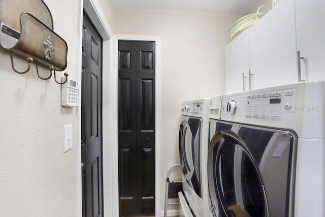 laundry room with cabinets and washer and dryer