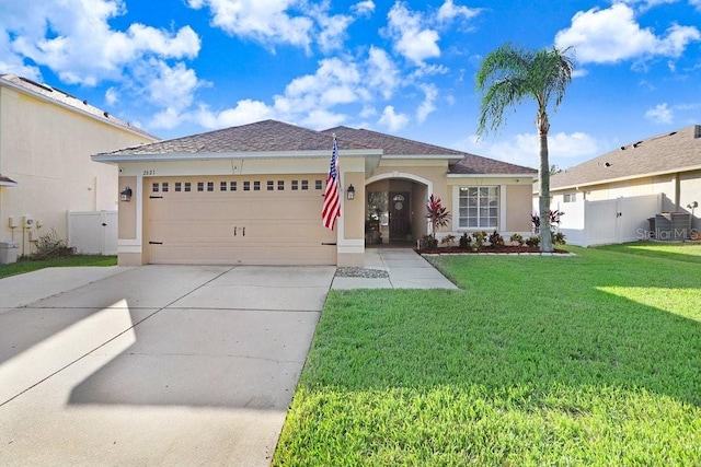 view of front of property featuring a garage and a front lawn