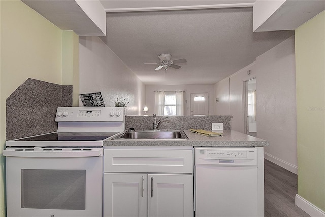 kitchen featuring dark hardwood / wood-style flooring, sink, white cabinets, white appliances, and ceiling fan