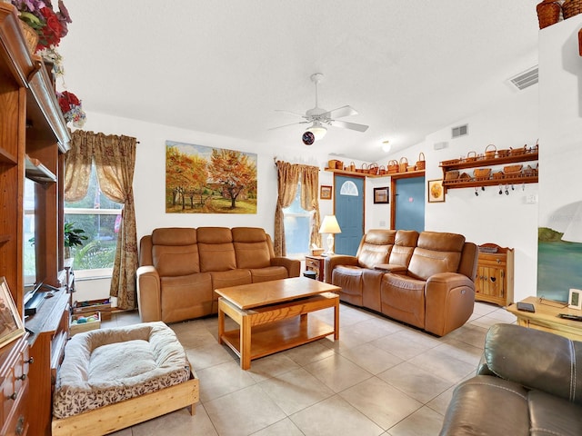 tiled living room with vaulted ceiling, ceiling fan, and a textured ceiling