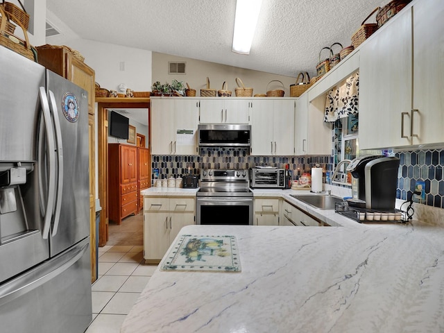 5800 W Spicey Hill Dr, Homosassa, FL 34448 - kitchen with stainless steel appliances, a sink, tasteful backsplash, light tile patterned floors, and a textured ceiling