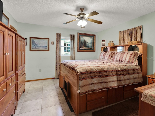 5800 W Spicey Hill Dr, Homosassa, FL 34448 - bedroom featuring a textured ceiling, a ceiling fan, light tile patterned floors, and baseboards