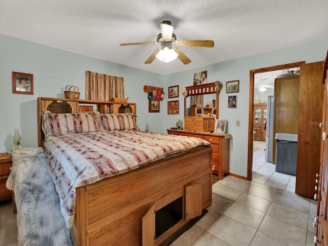 tiled bedroom featuring ceiling fan, a textured ceiling, and stainless steel fridge