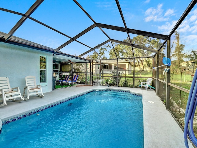 5800 W Spicey Hill Dr, Homosassa, FL 34448 - swimming pool featuring a patio, glass enclosure, and a ceiling fan