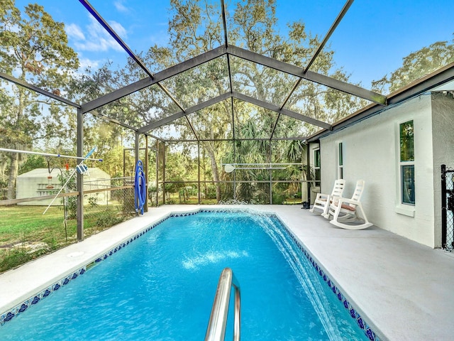 view of pool featuring glass enclosure and a patio area