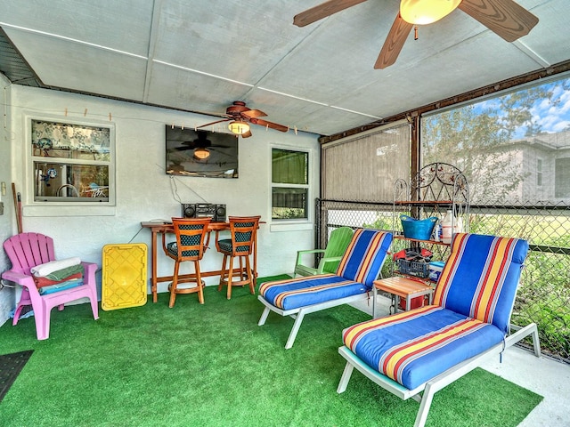 sunroom / solarium featuring ceiling fan