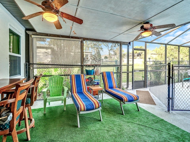 sunroom / solarium featuring ceiling fan