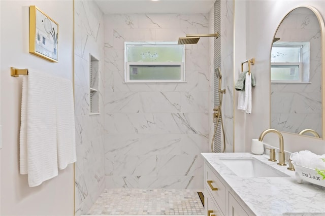 bathroom with vanity and tiled shower