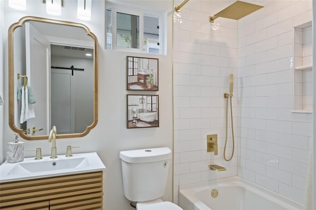 full bathroom featuring tiled shower / bath, vanity, and toilet