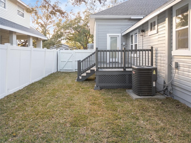 view of yard with a deck and central air condition unit