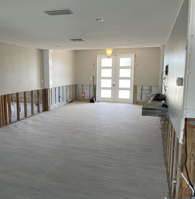 interior space featuring french doors and light wood-type flooring