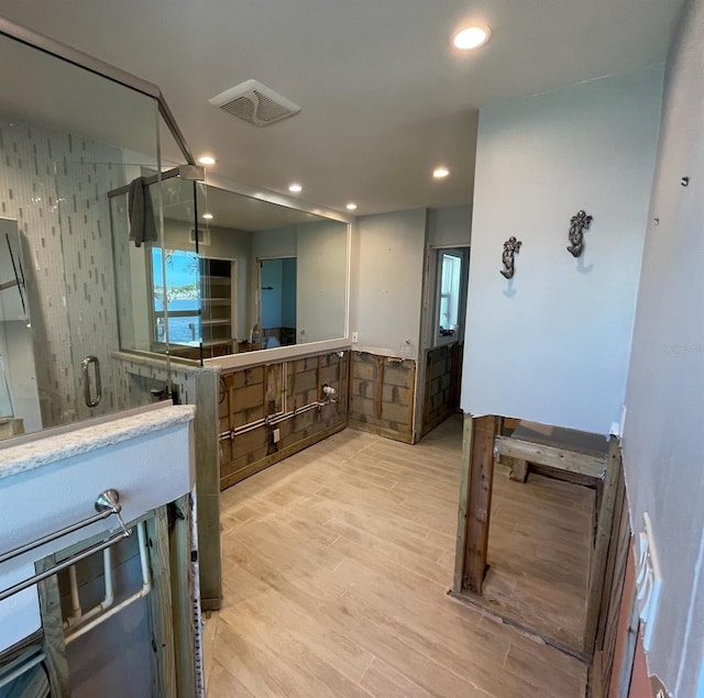 bathroom featuring backsplash and hardwood / wood-style flooring