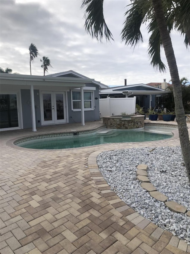 view of pool featuring french doors and a patio