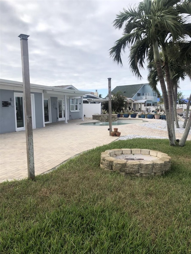 view of yard with an outdoor fire pit and a patio area