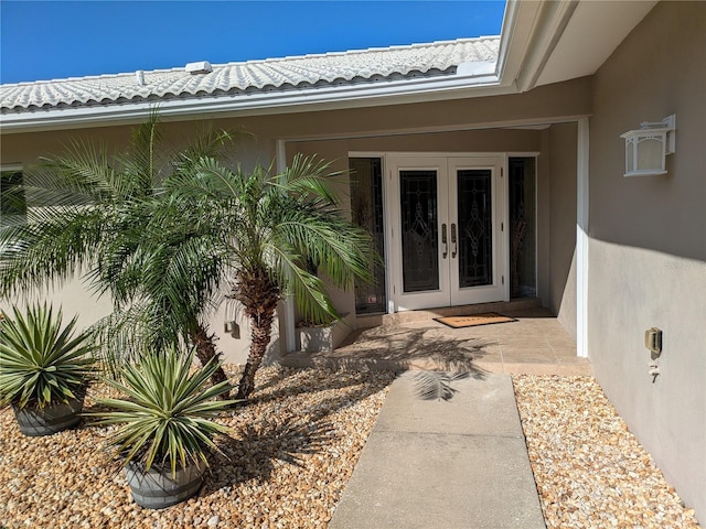 212 Poinciana Ln, Largo, FL 33770 - property entrance featuring french doors and stucco siding