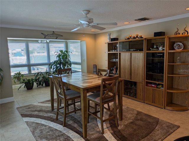 212 Poinciana Ln, Largo, FL 33770 - dining room featuring ceiling fan, ornamental molding, a textured ceiling, and light tile patterned floors