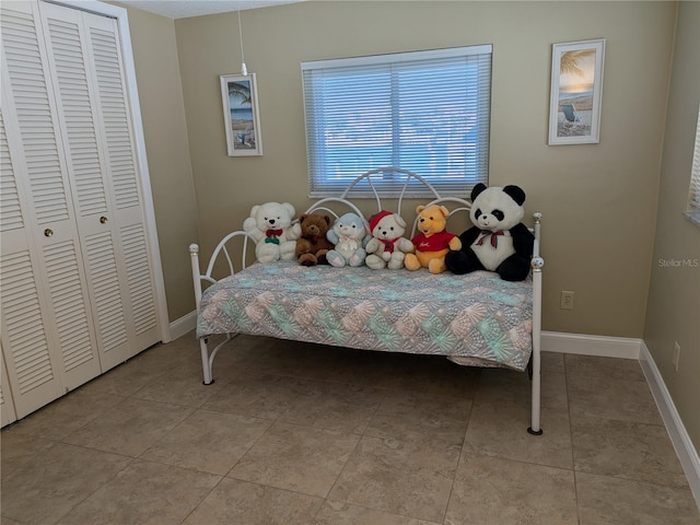 tiled bedroom featuring a closet