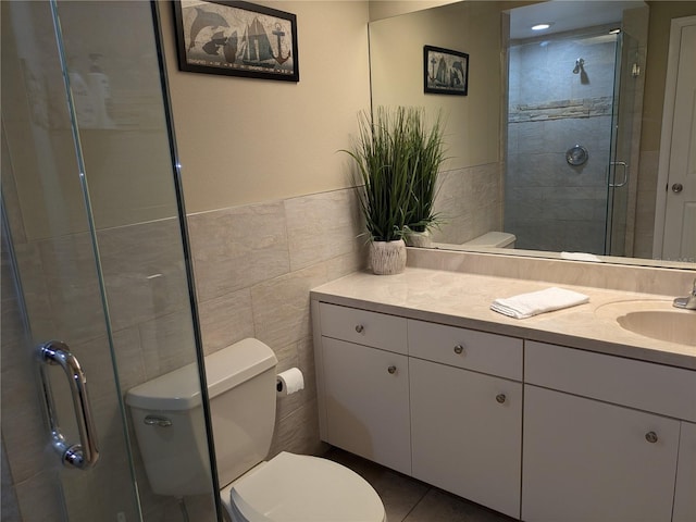 bathroom with vanity, an enclosed shower, tile walls, and toilet