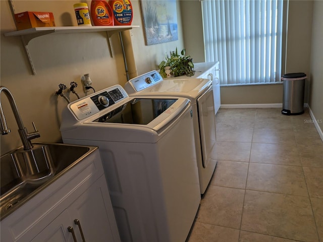 212 Poinciana Ln, Largo, FL 33770 - laundry room with washer and clothes dryer, light tile patterned floors, baseboards, and cabinet space