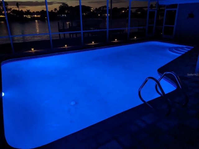 view of pool with a water view