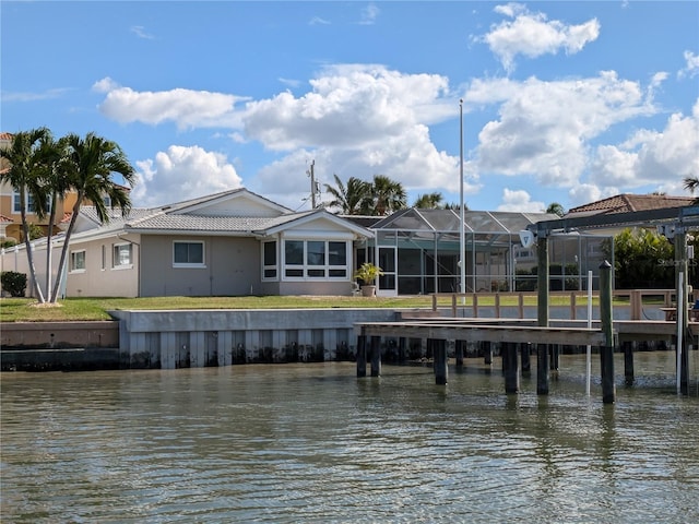 view of dock featuring a lawn and a water view