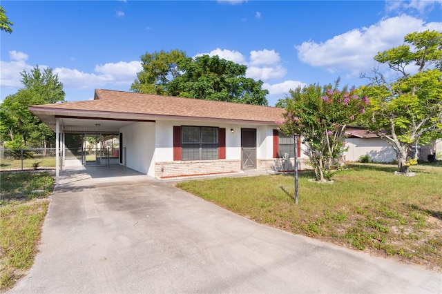 view of front facade with a front yard and a carport