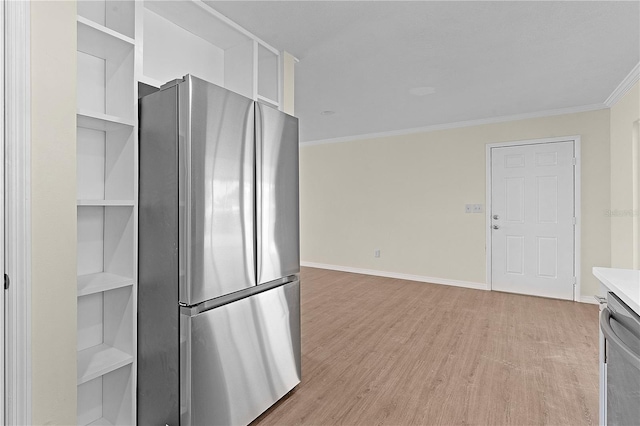 kitchen featuring appliances with stainless steel finishes, light hardwood / wood-style flooring, and crown molding