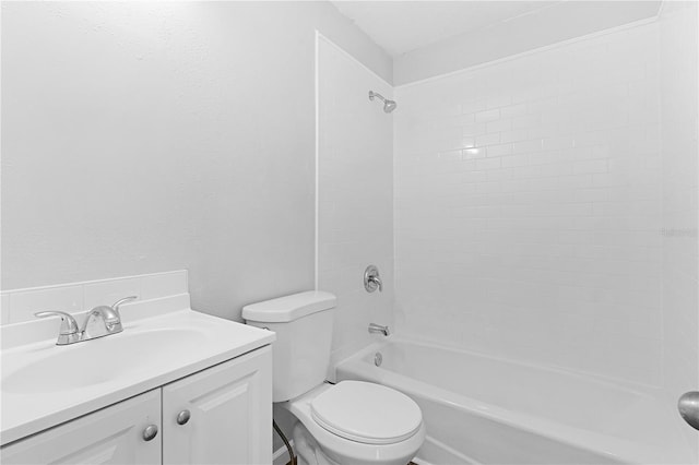 full bathroom with tiled shower / bath, vanity, and toilet