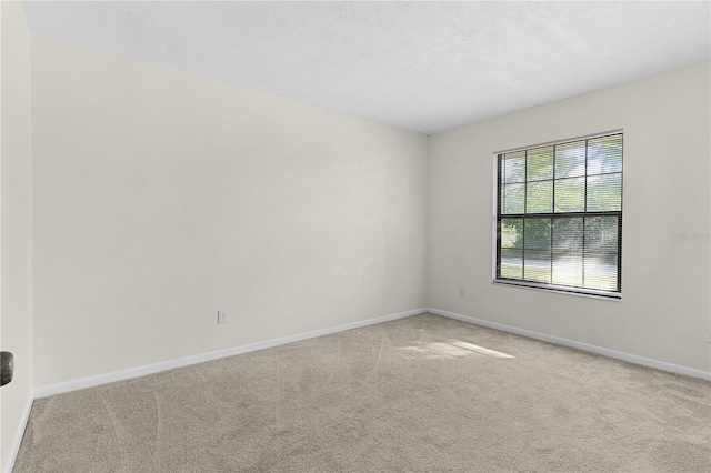 unfurnished room with light colored carpet