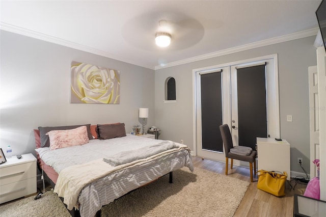 bedroom with light hardwood / wood-style floors, access to exterior, and ornamental molding