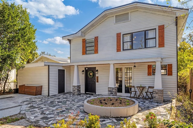 rear view of property with covered porch