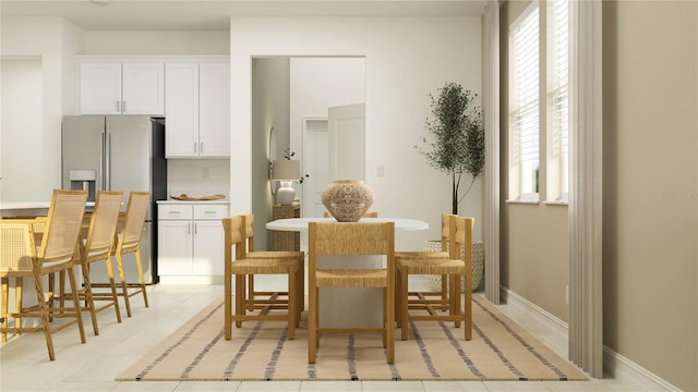 dining space featuring light tile patterned floors