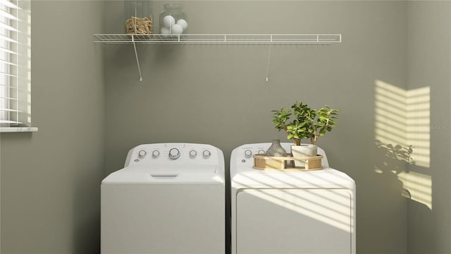 laundry area with washing machine and clothes dryer