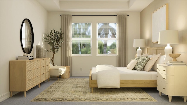 bedroom with dark carpet and a raised ceiling