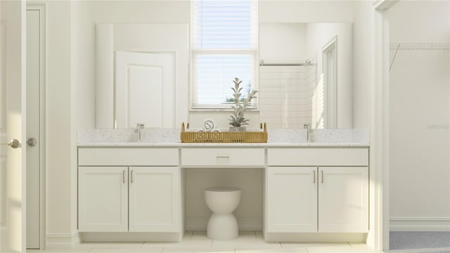 bathroom featuring tile patterned flooring and vanity