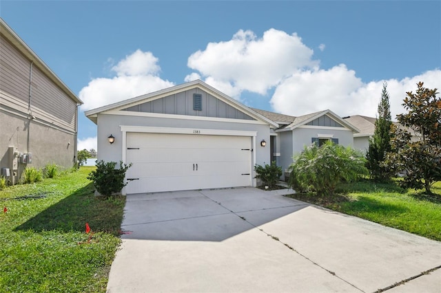 view of front of home with a garage and a front lawn