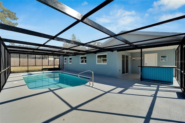 view of swimming pool with a patio and glass enclosure