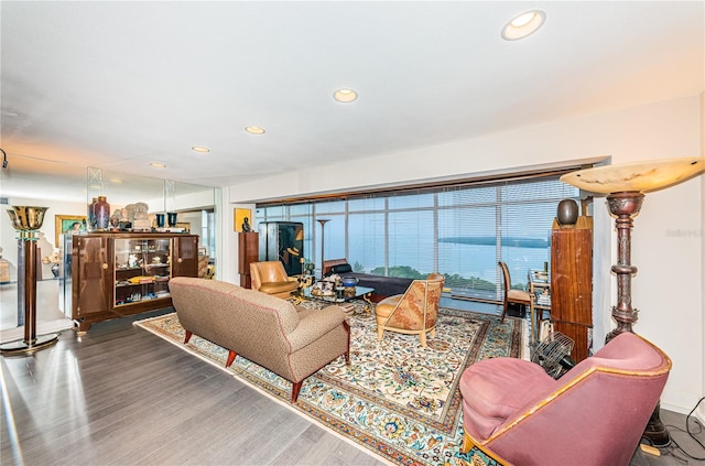 living room with hardwood / wood-style flooring and a water view