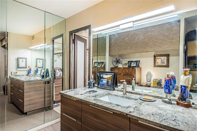 bathroom featuring tile walls and vanity