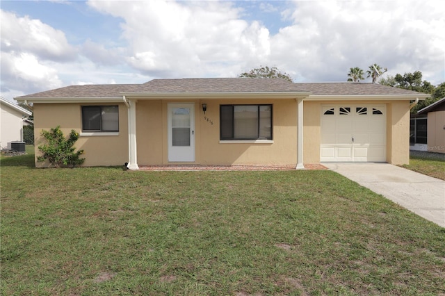 ranch-style house featuring a front yard, a garage, and central AC unit