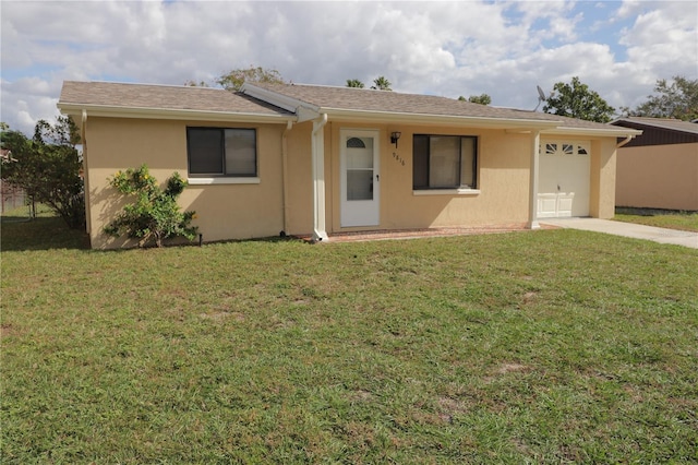 ranch-style house with a garage and a front lawn