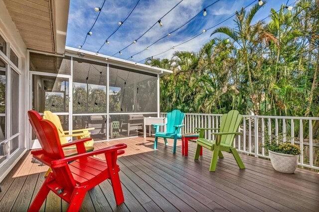 wooden deck featuring a sunroom