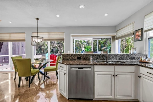 kitchen with stainless steel dishwasher, a sink, white cabinetry, and recessed lighting