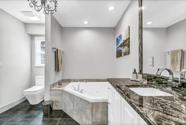 full bathroom featuring toilet, vanity, baseboards, a jetted tub, and tile patterned floors