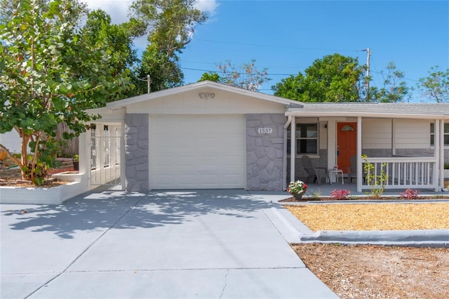 ranch-style home featuring covered porch and a garage